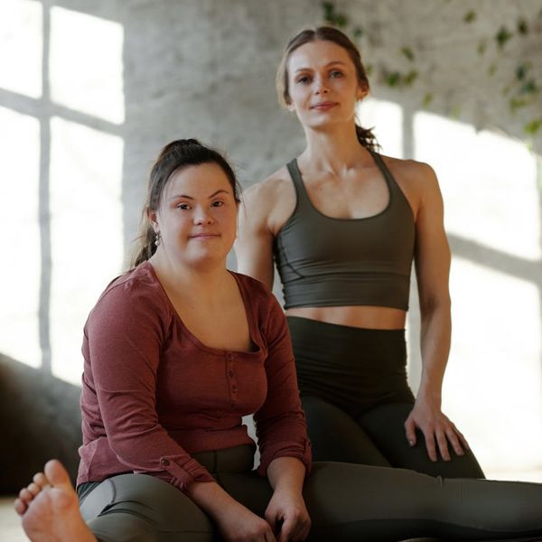 Person sitting cross-legged, meditating peacefully.